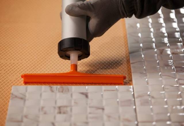 Adhesive spreader